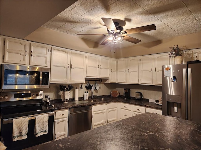 kitchen with white cabinets, ceiling fan, and stainless steel appliances