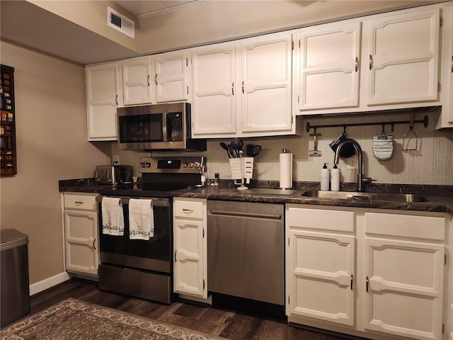 kitchen with white cabinets, appliances with stainless steel finishes, and sink