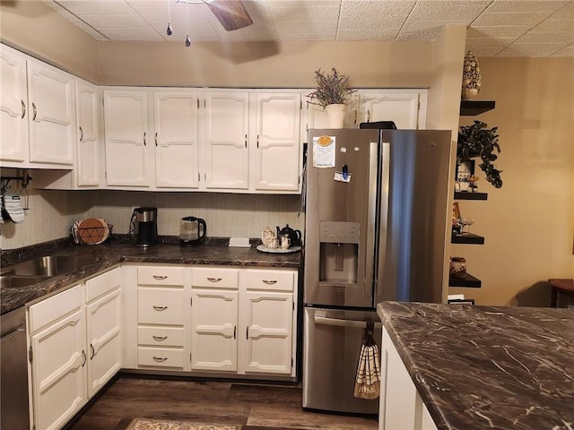 kitchen featuring white cabinetry, dark wood-type flooring, and appliances with stainless steel finishes