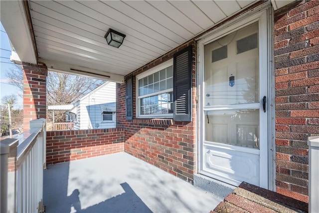 view of exterior entry with a porch