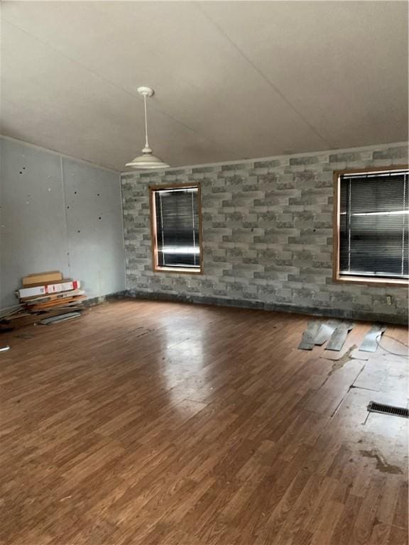 unfurnished room with dark hardwood / wood-style floors and lofted ceiling