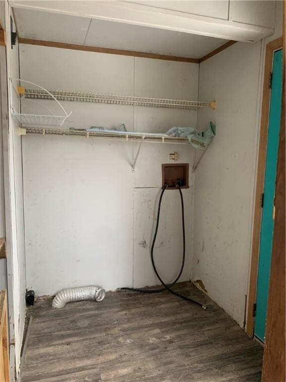 clothes washing area featuring dark hardwood / wood-style flooring and washer hookup