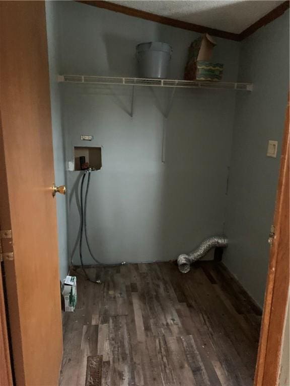 laundry room with dark wood-type flooring, washer hookup, and ornamental molding