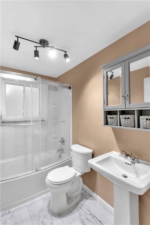 full bathroom featuring toilet, enclosed tub / shower combo, and sink