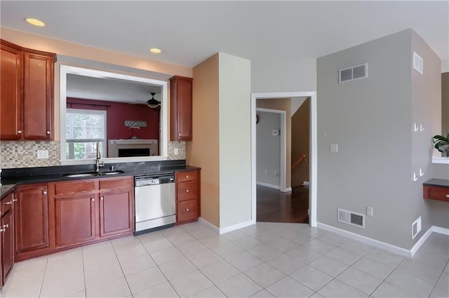 kitchen featuring sink, stainless steel dishwasher, ceiling fan, decorative backsplash, and light tile patterned flooring