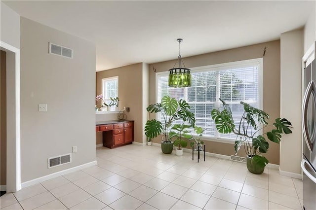 interior space with light tile patterned floors and a chandelier