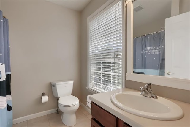 bathroom featuring curtained shower, tile patterned flooring, vanity, and toilet