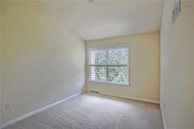 spare room featuring light colored carpet