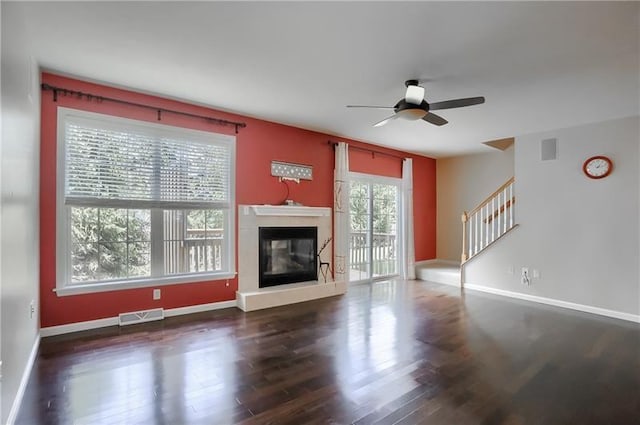 unfurnished living room featuring ceiling fan and dark hardwood / wood-style floors