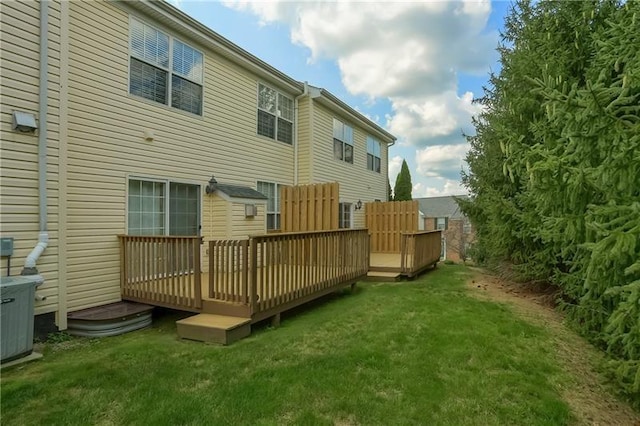 back of property featuring central AC, a yard, and a deck