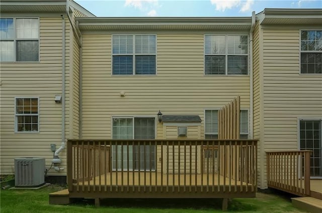 back of house with a deck and central air condition unit