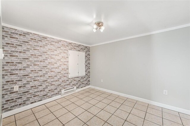 empty room featuring light tile patterned floors, brick wall, ornamental molding, and baseboards