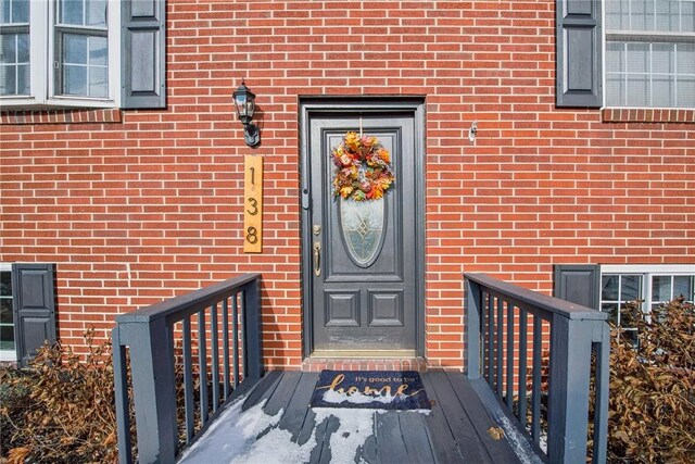 entrance to property with brick siding