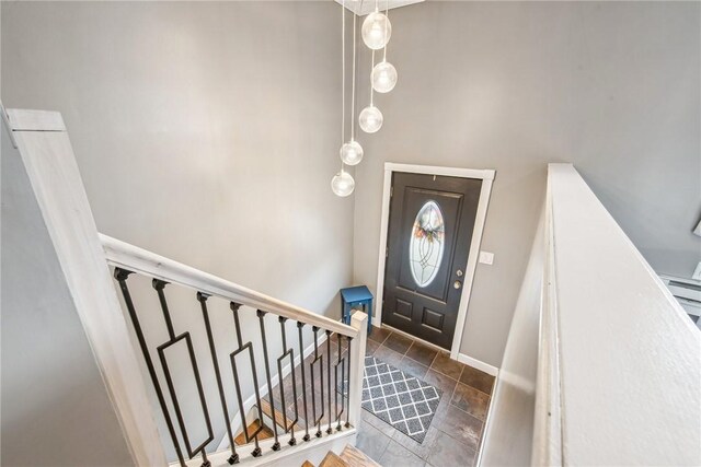 foyer entrance featuring baseboards and stairway