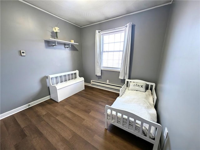 bedroom featuring a baseboard radiator, wood finished floors, and baseboards