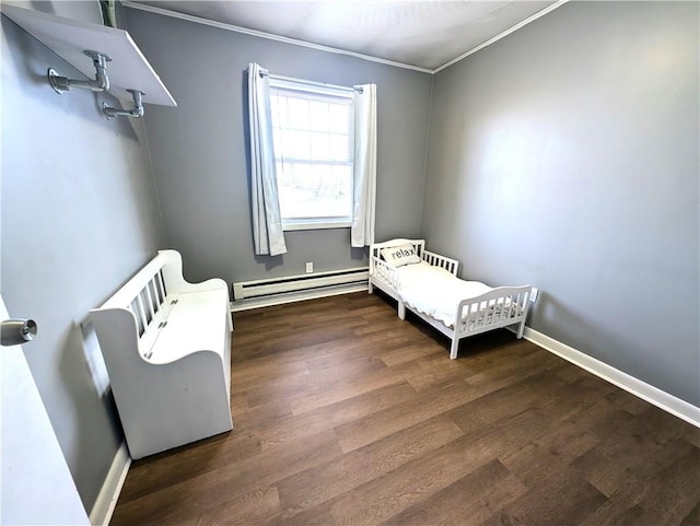 bedroom featuring baseboards, baseboard heating, wood finished floors, and ornamental molding