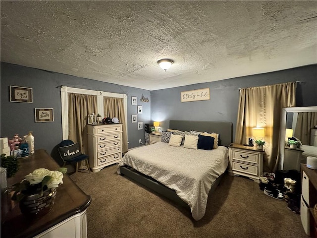 bedroom with dark carpet and a textured ceiling