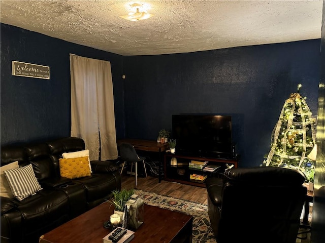 living room featuring a textured ceiling and hardwood / wood-style flooring