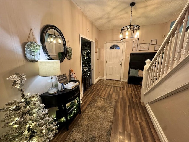 entrance foyer with a chandelier and dark wood-type flooring