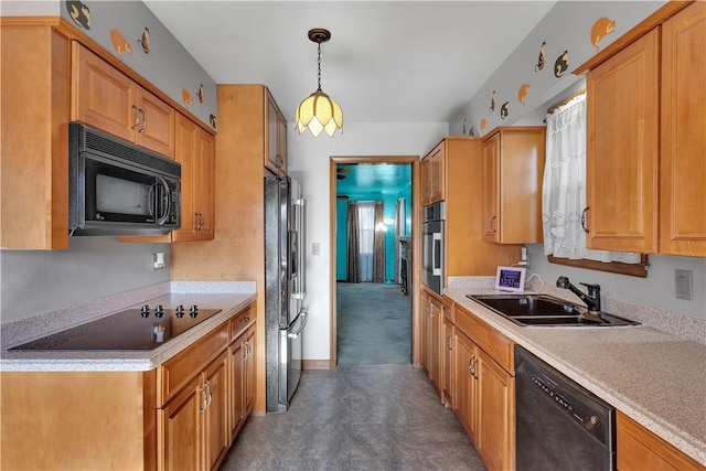 kitchen featuring black appliances, sink, and hanging light fixtures