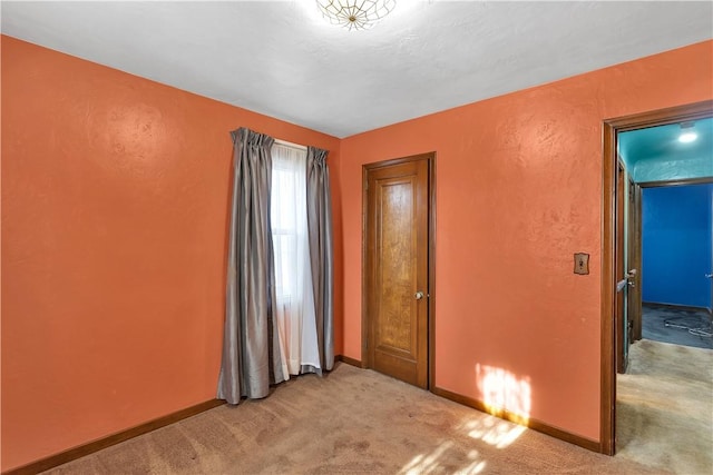 unfurnished bedroom featuring light colored carpet