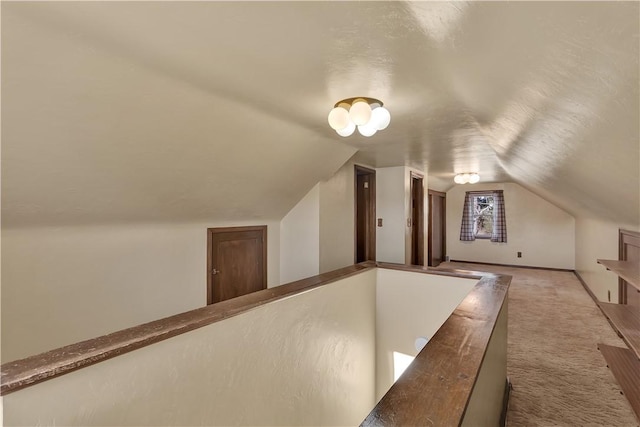 additional living space with light colored carpet and lofted ceiling