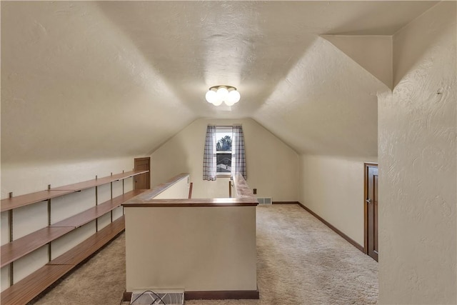 bonus room featuring light carpet, a textured ceiling, and vaulted ceiling