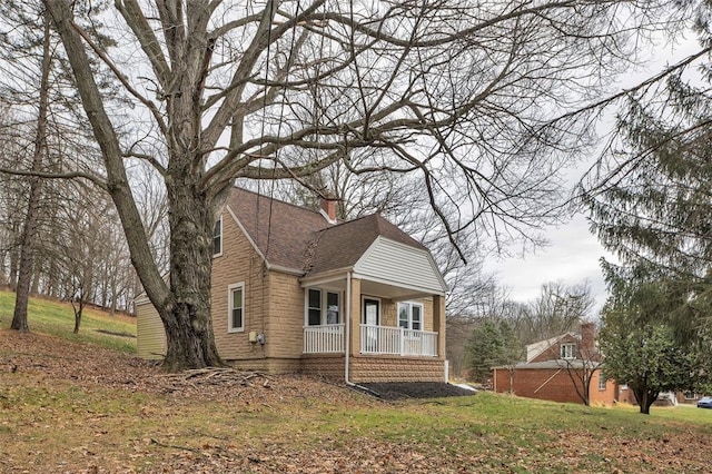 view of side of property with covered porch