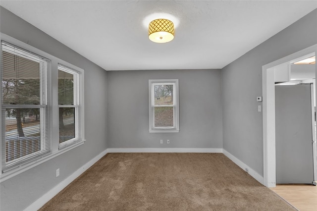 unfurnished room with light colored carpet