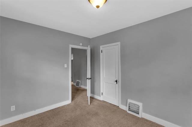 unfurnished bedroom with light colored carpet