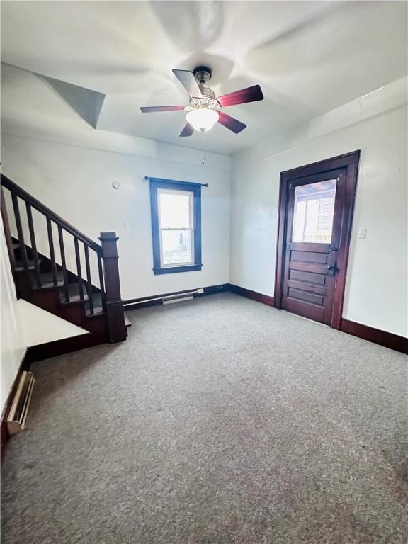 unfurnished living room featuring carpet floors, a wealth of natural light, and ceiling fan