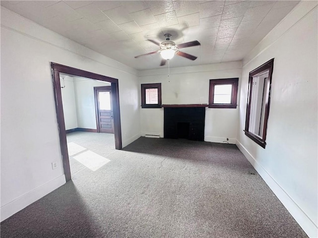 unfurnished living room featuring carpet flooring, ceiling fan, and a baseboard radiator