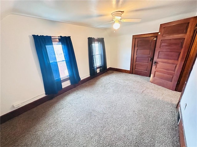 spare room featuring carpet and ceiling fan