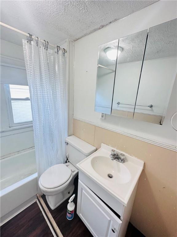 full bathroom with hardwood / wood-style flooring, shower / bath combo, a textured ceiling, and vanity