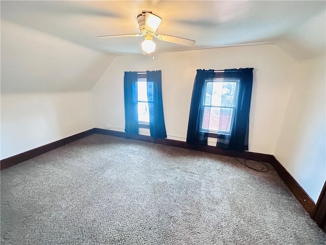 additional living space with ceiling fan, carpet, and lofted ceiling