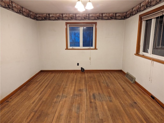 spare room with hardwood / wood-style flooring