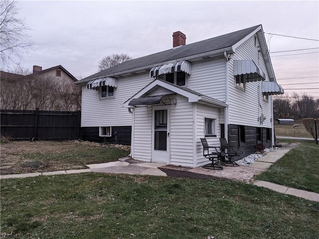 rear view of house with a yard