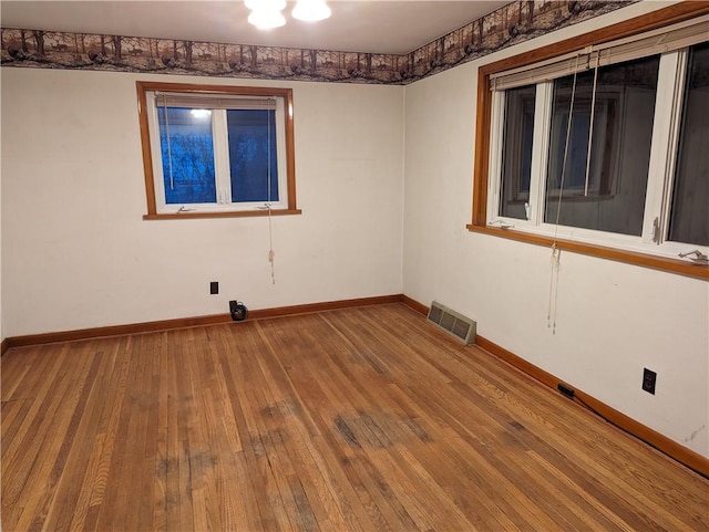 spare room with hardwood / wood-style floors