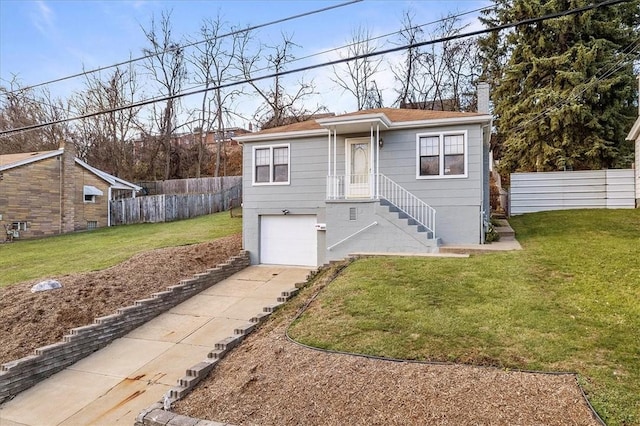 view of front of property featuring a front yard and a garage