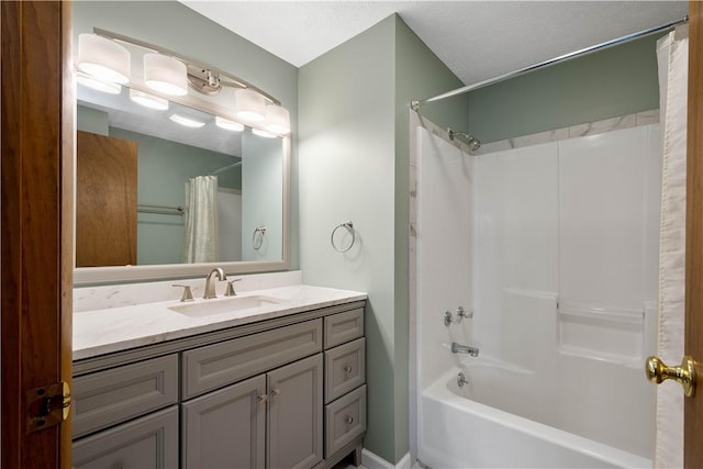 bathroom with shower / bath combo, a textured ceiling, and vanity