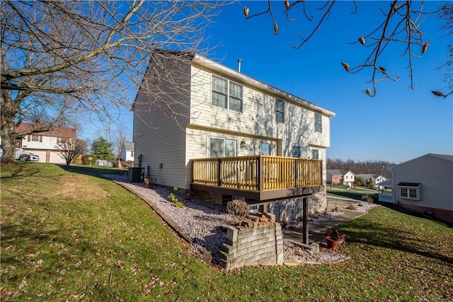 back of property featuring a lawn, central AC unit, and a deck