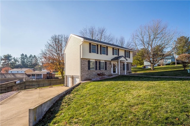 view of front of property with a garage and a front yard