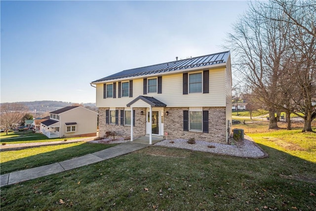 view of front of house featuring a front lawn and central air condition unit