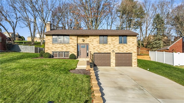 raised ranch featuring a front yard and a garage