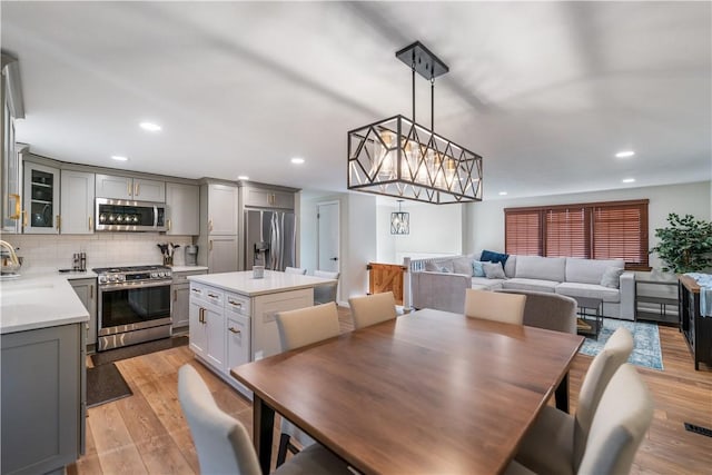 dining area featuring light hardwood / wood-style flooring and sink