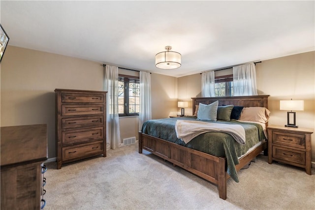 carpeted bedroom featuring multiple windows