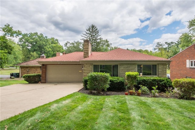 single story home with a garage and a front lawn