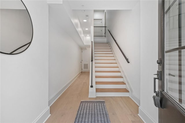 staircase with wood-type flooring