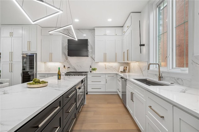 kitchen featuring white cabinetry, hanging light fixtures, and sink