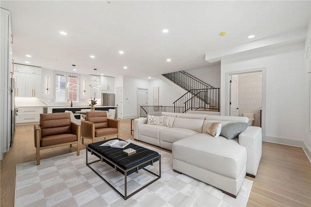 living room featuring light wood-type flooring and sink